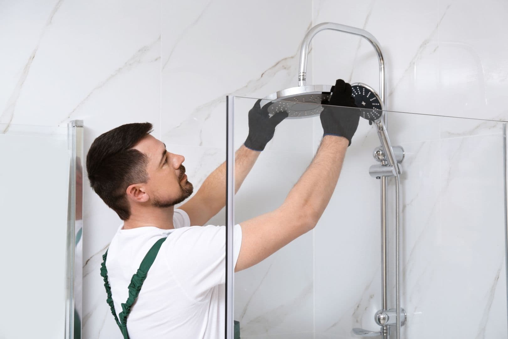 Professional Handyman Working In Shower Booth Indoors.